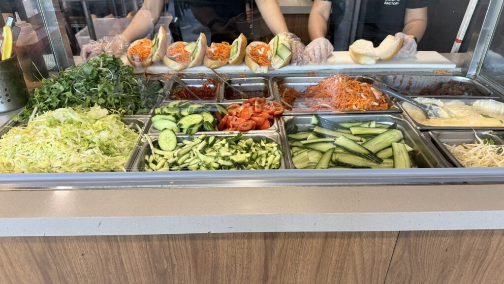 Bánh Mì Factory Zillmere menu board showing banh mi, noodle salad, rice paper rolls and pho prices
